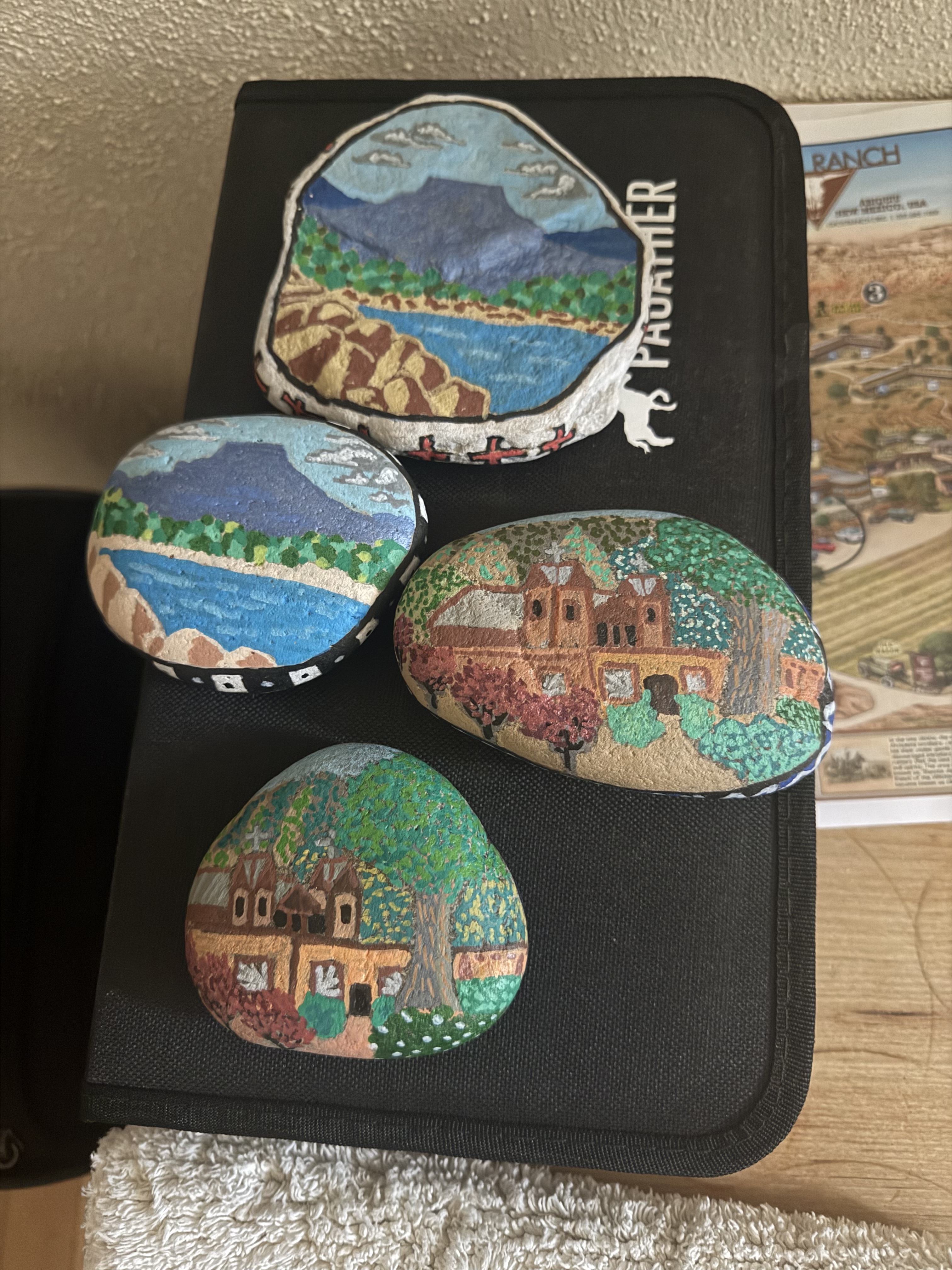 Painted rocks with scenes from the New Mexico desert and El Santaurio De Chimayo